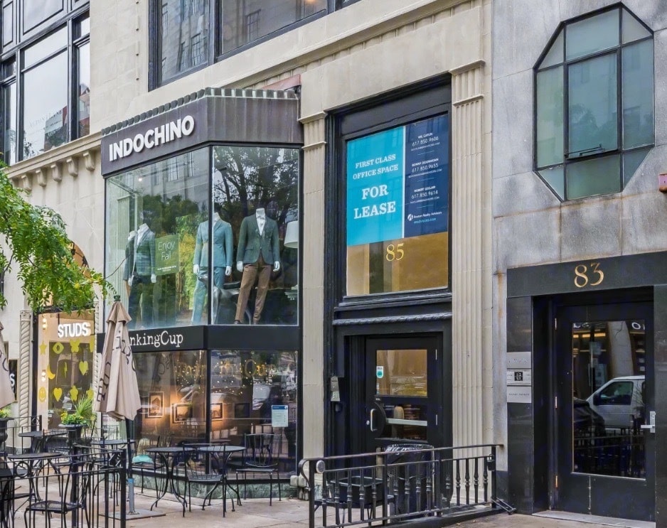 a city store front with a building in the background