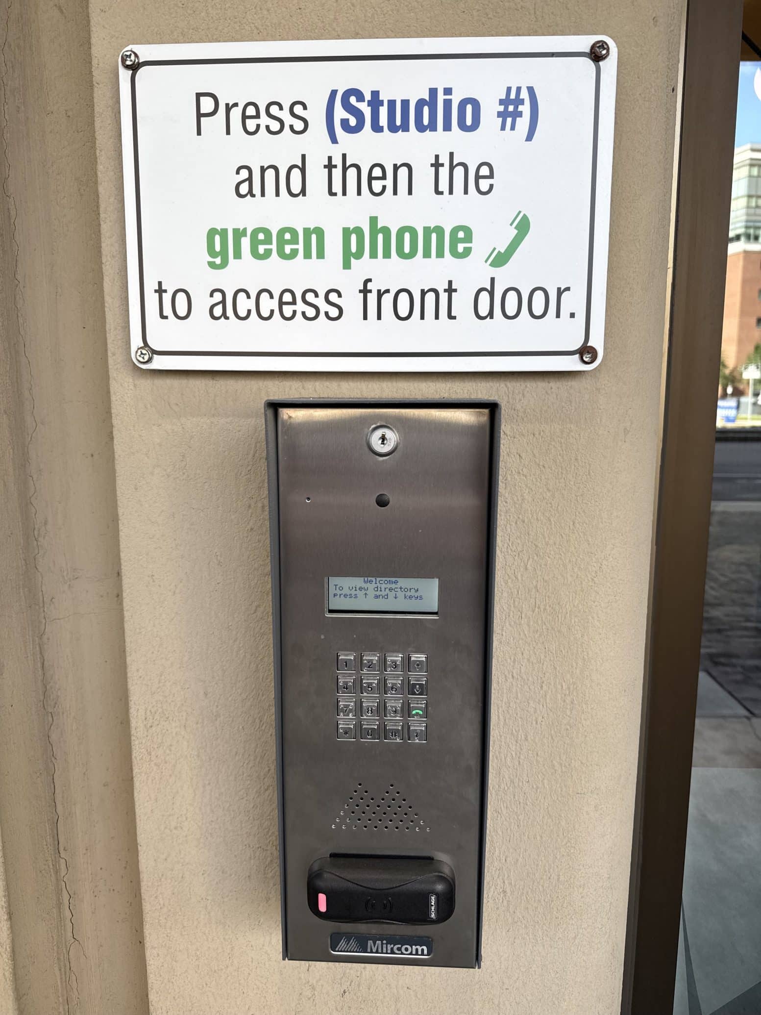 a parking meter that has a sign on the side of a building