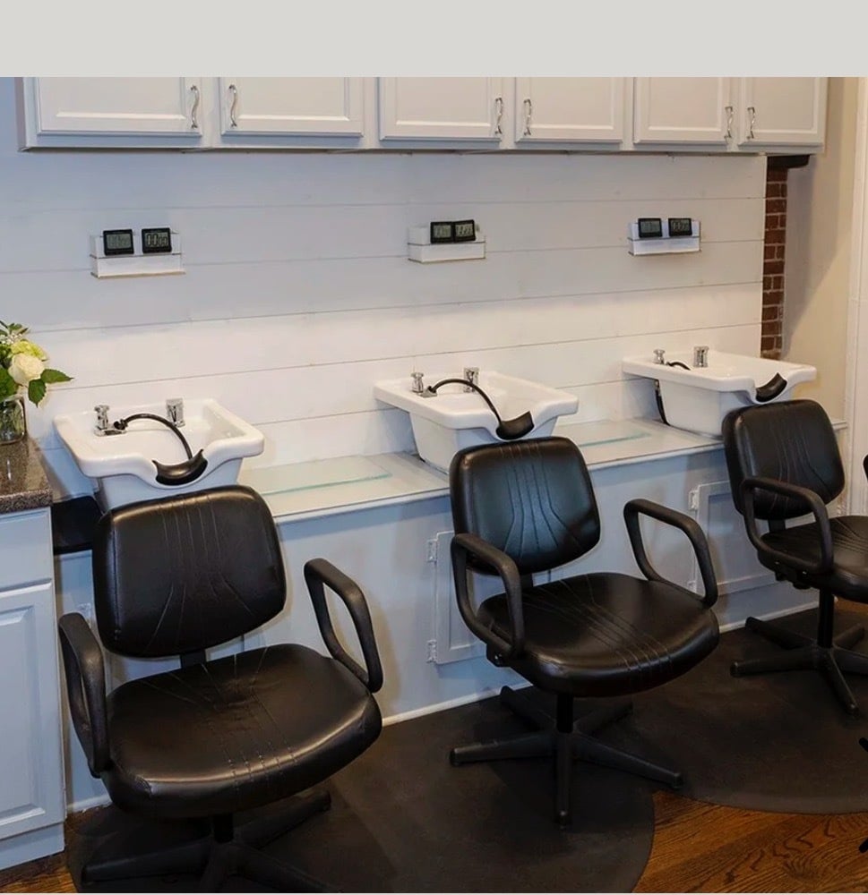 a desk with a computer and a chair in a room